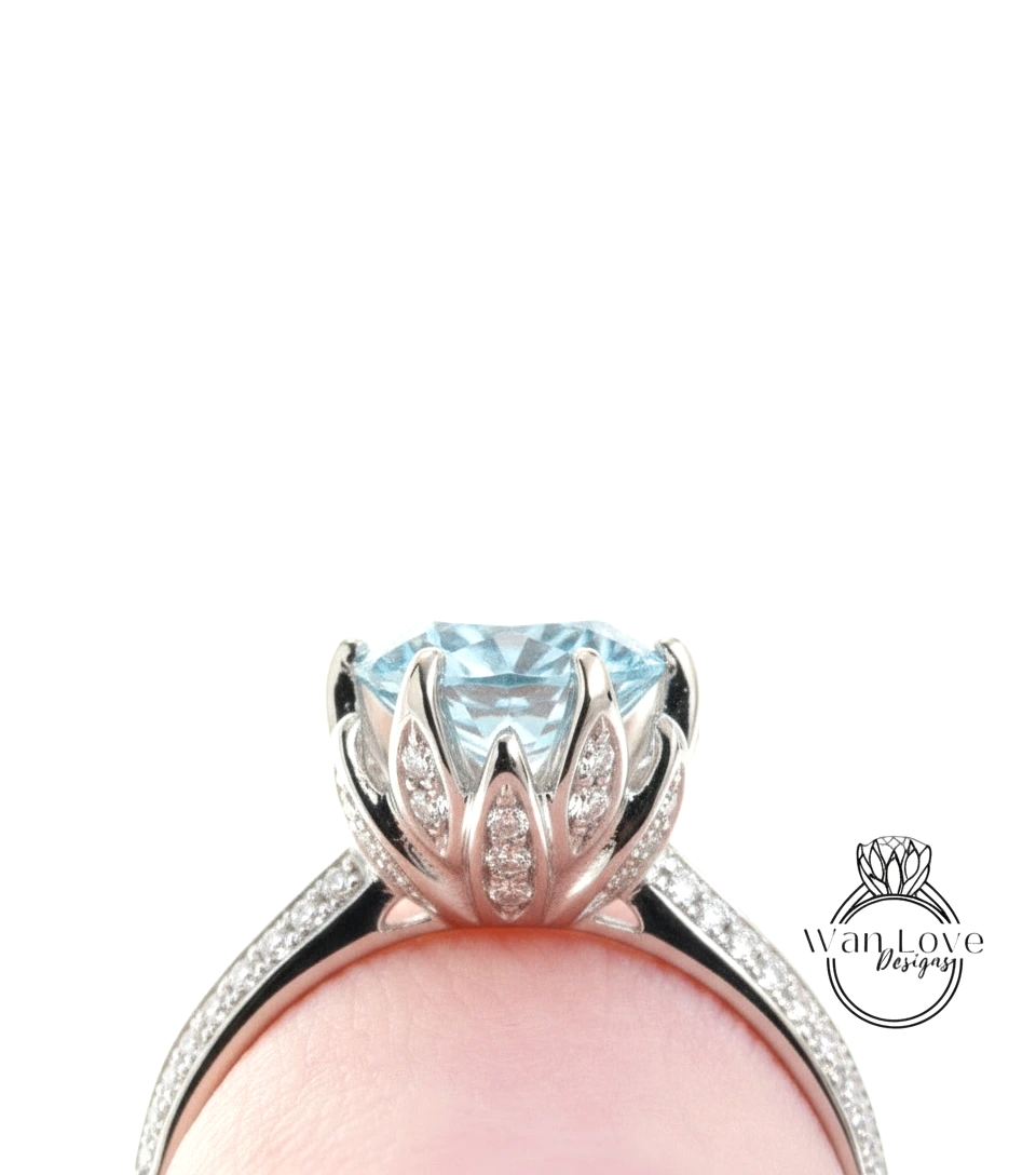 A close-up view of a diamond engagement ring with a large blue gemstone set in a silver band.