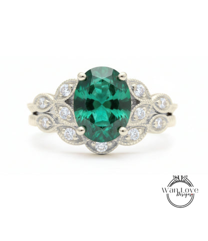 A silver ring with a large oval-shaped green gemstone surrounded by smaller diamonds.