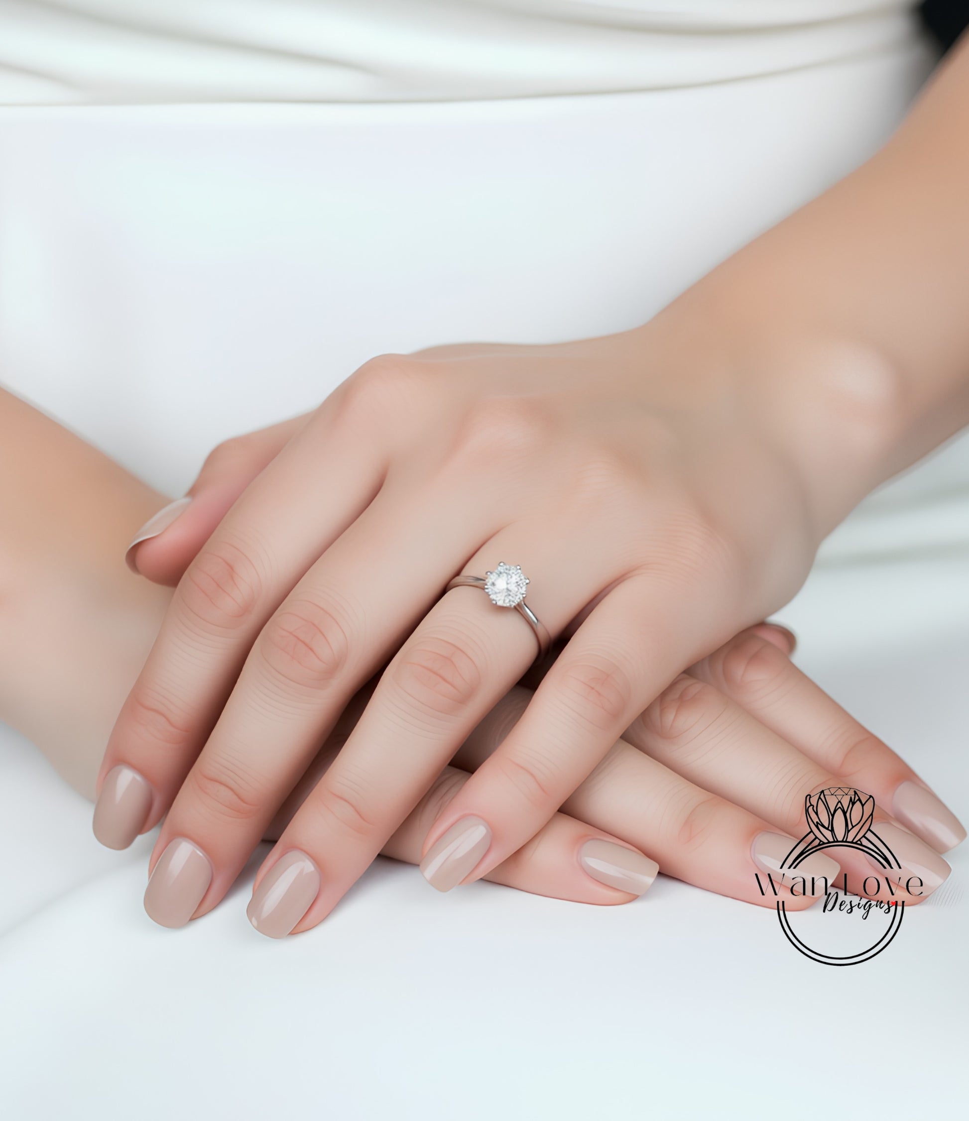 A close-up image of a person's hand wearing a diamond engagement ring.