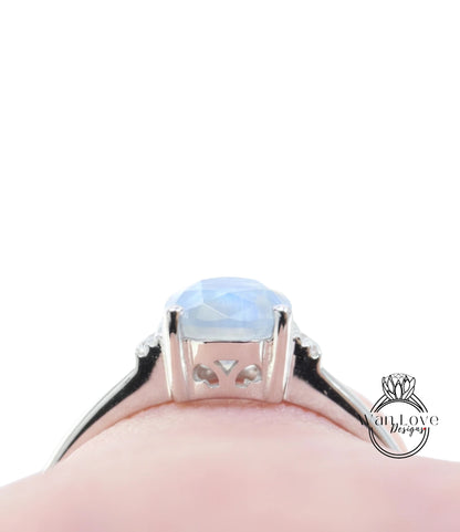 A close-up view of a silver ring with a blue gemstone, likely a sapphire, set in a halo of smaller diamonds.