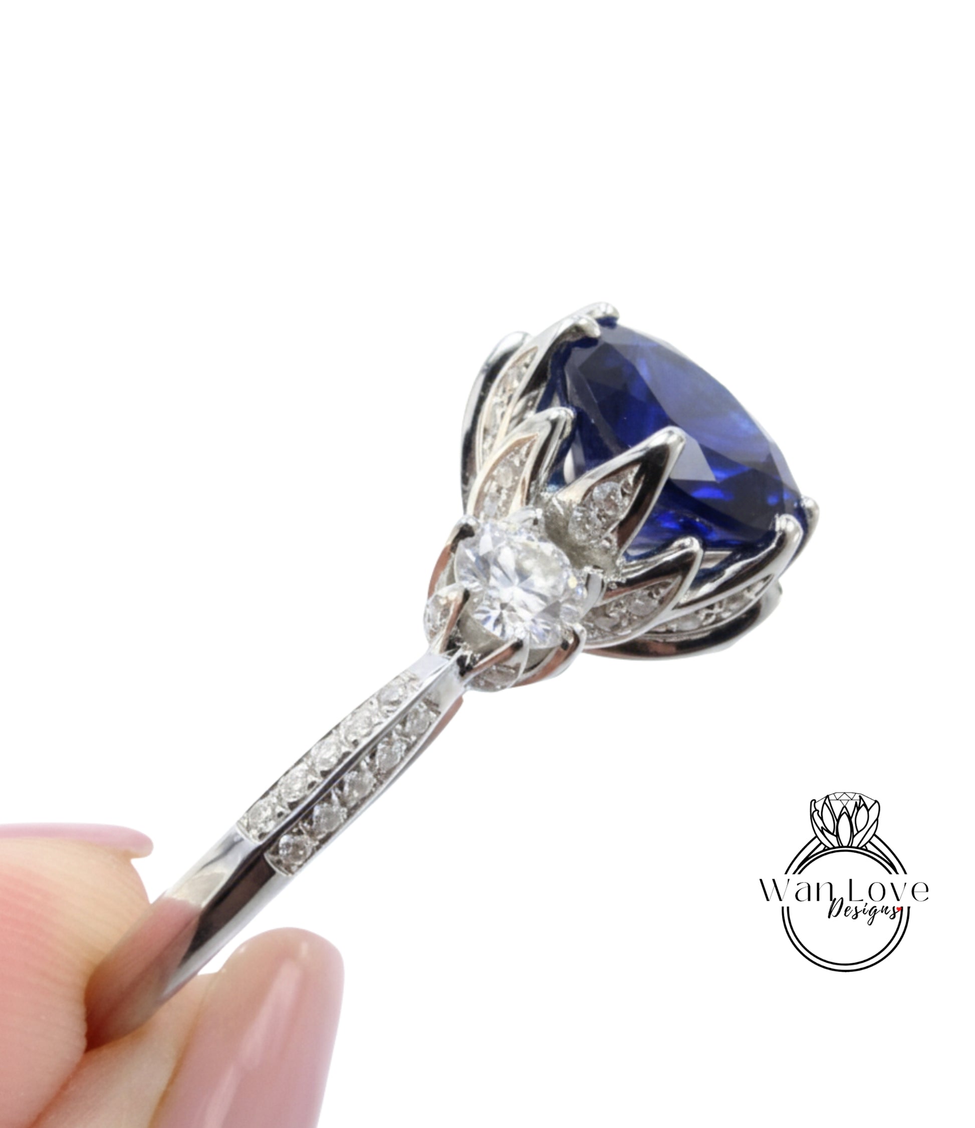 A close-up view of a diamond engagement ring with a large blue gemstone set in a silver band.