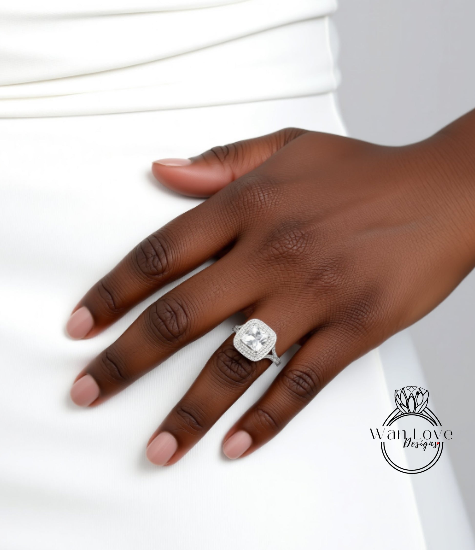 A close-up of a hand wearing a diamond engagement ring.
