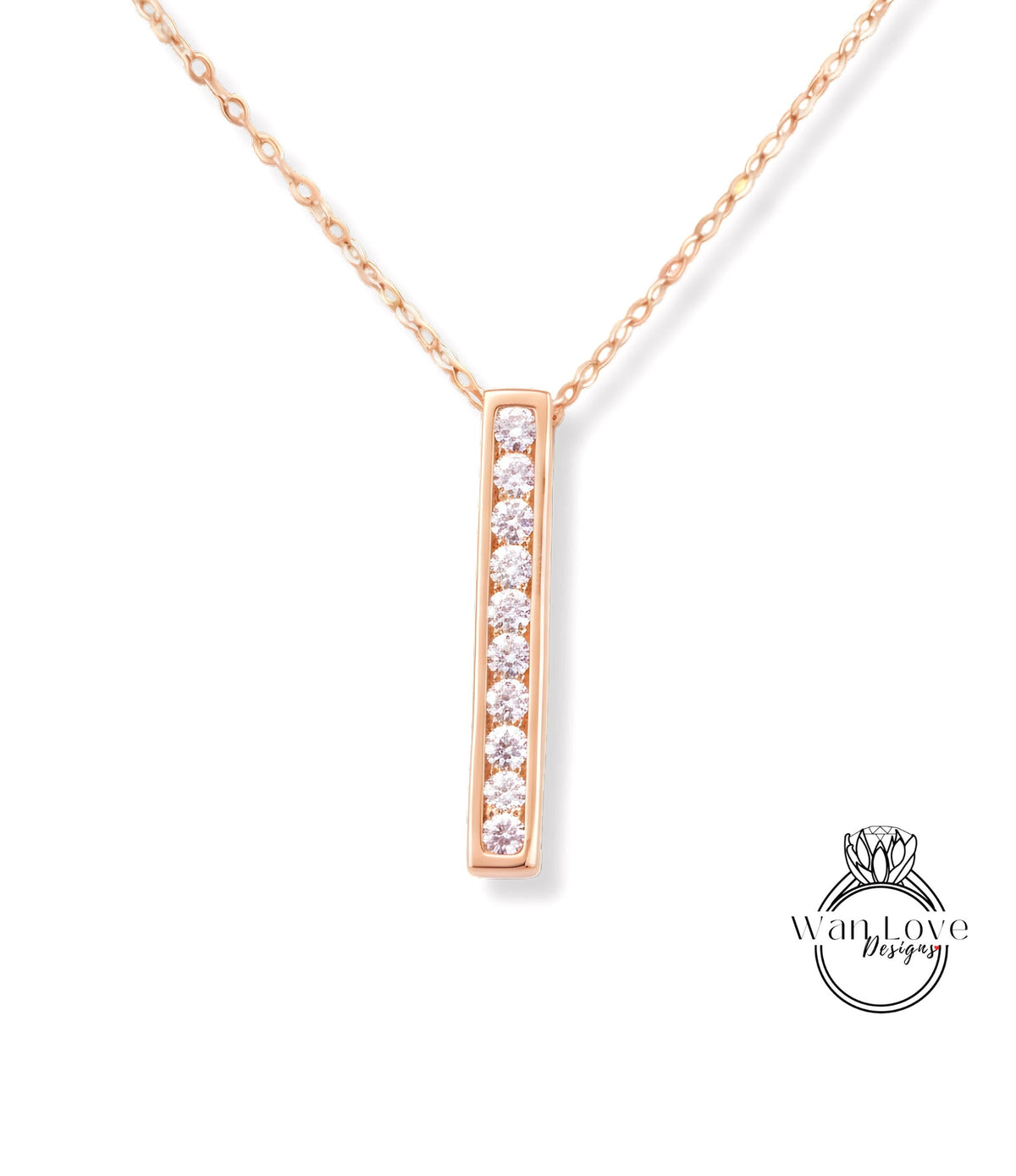 A delicate gold necklace with a single, rectangular pendant featuring a row of small diamonds.