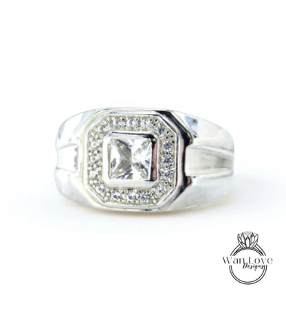 A silver ring with a large central diamond surrounded by smaller diamonds.