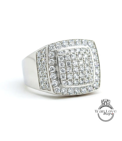 A silver ring with a large diamond-encrusted square in the center.