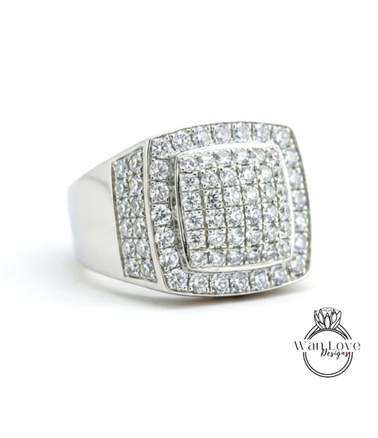 A silver ring with a large diamond-encrusted square in the center.