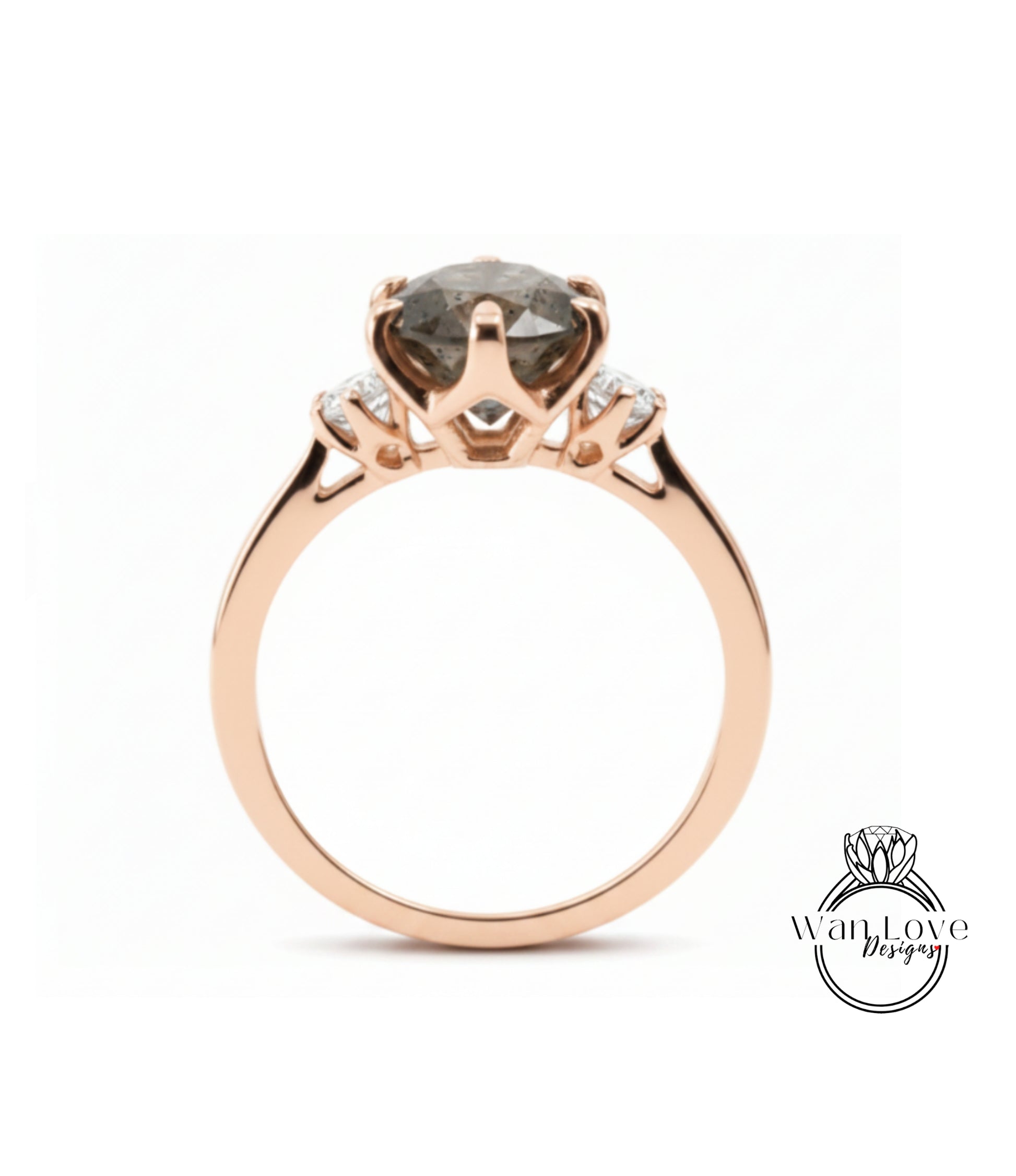 A rose gold engagement ring with a large, dark grey diamond as the centerpiece, set in a three-pronged design.