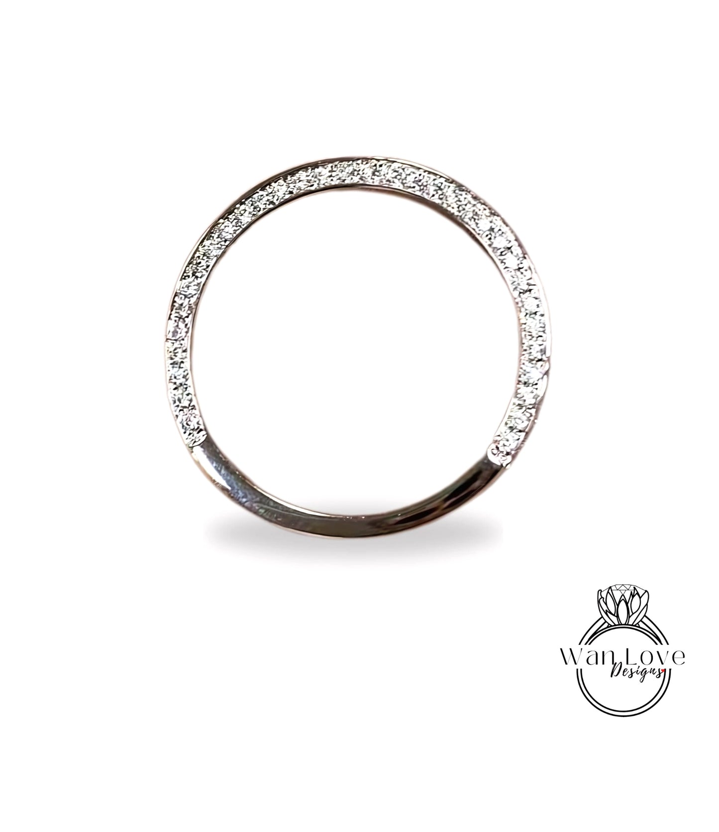 A silver ring with a row of diamonds along the edge.