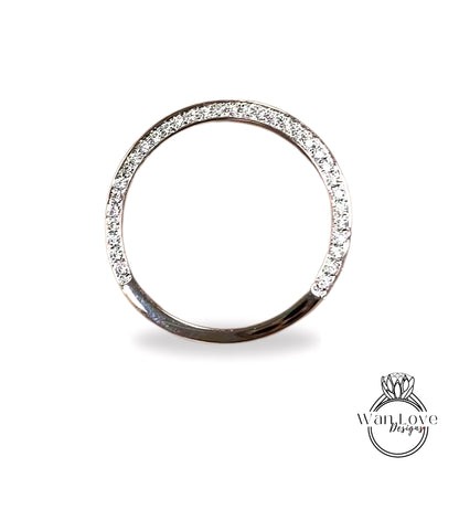 A silver ring with a row of diamonds along the edge.
