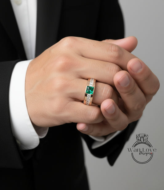 A close-up of a person's hand wearing a gold ring with a green gemstone.