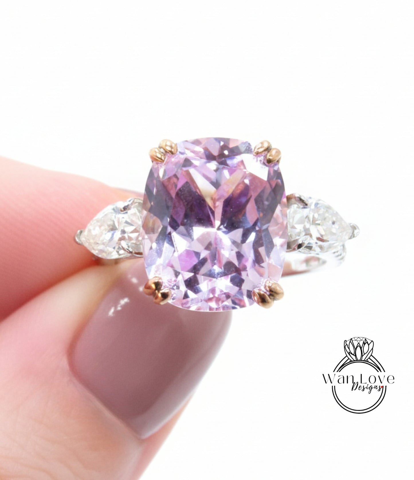 A close-up image of a person's hand holding a ring with a large, purple gemstone.