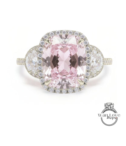 A large, pink gemstone ring with a halo of smaller diamonds around it.