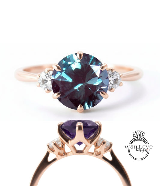 a gold ring with a large blue gemstone, likely a sapphire, set in a rose gold band.