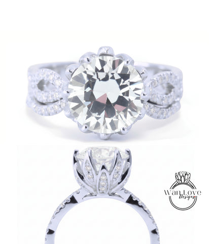 A stunning diamond engagement ring with a large round brilliant cut diamond set in a silver band adorned with smaller diamonds.