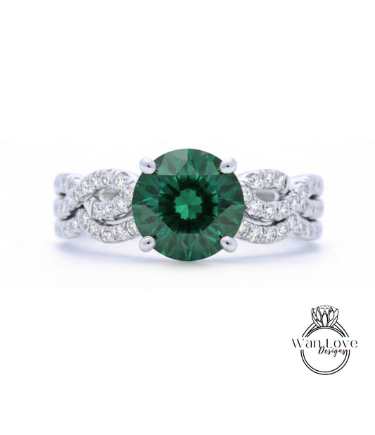 A close-up of a silver ring with a large, green gemstone at the center.