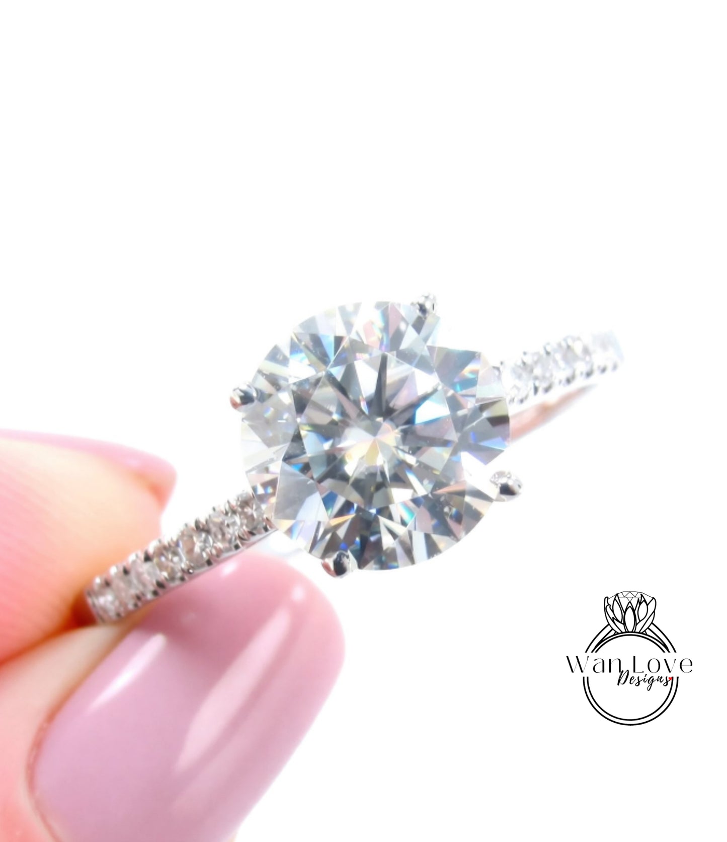 A close-up of a diamond engagement ring being held in a person's hand, showcasing the sparkling center stone.
