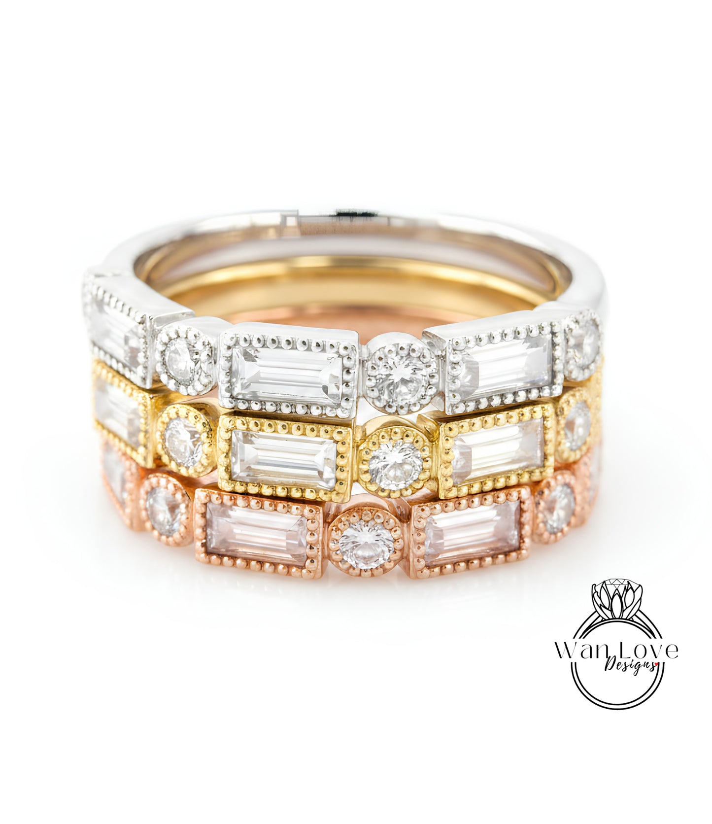 A close-up image of a stack of rings with various colored gemstones, including clear, white, and multicolored stones.