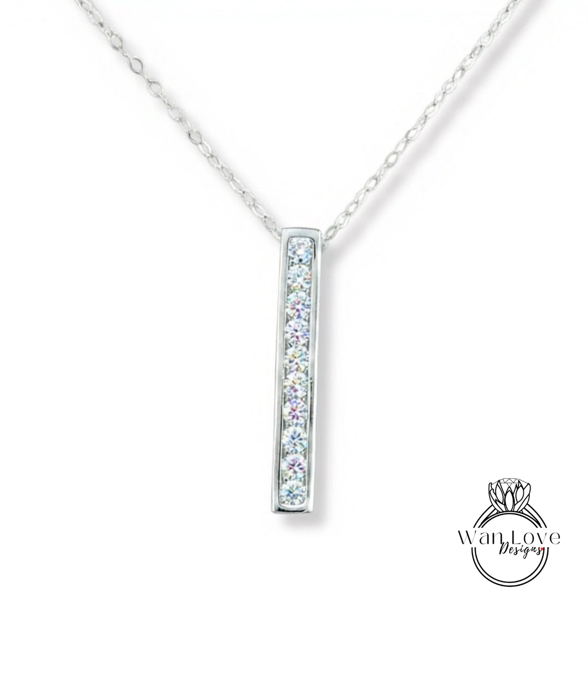 A silver necklace with a rectangular pendant featuring a row of small diamonds.