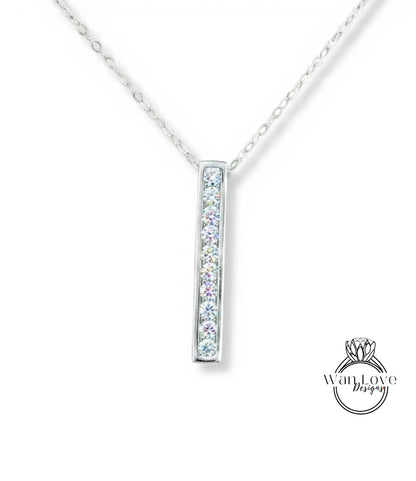 A silver necklace with a rectangular pendant featuring a row of small diamonds.