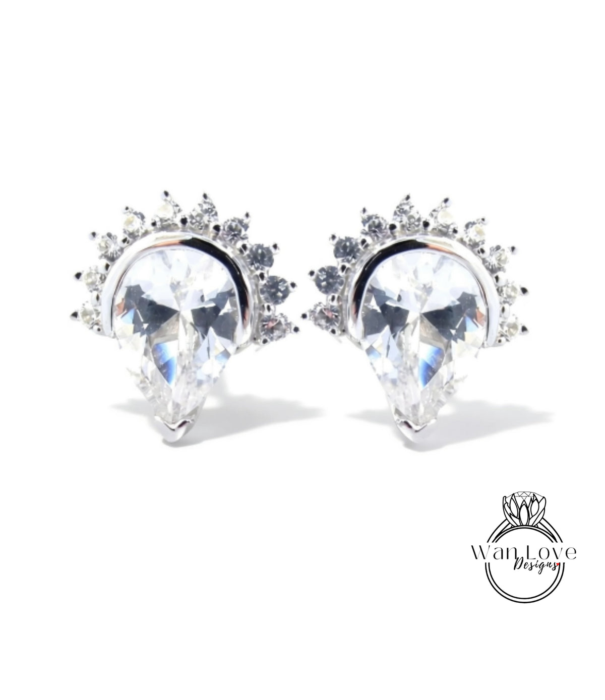 A pair of elegant earrings with large, clear gemstones set in a decorative metal frame.