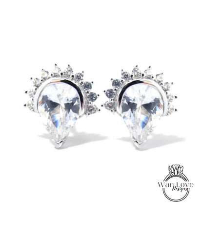 A pair of elegant earrings with large, clear gemstones set in a decorative metal frame.