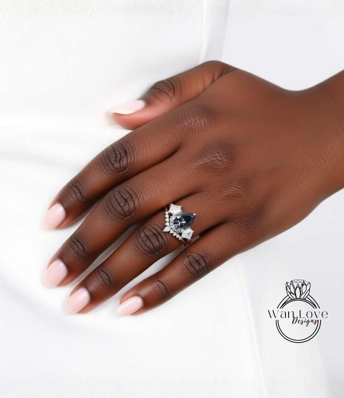 A close-up of a hand wearing a ring with a large blue gemstone.