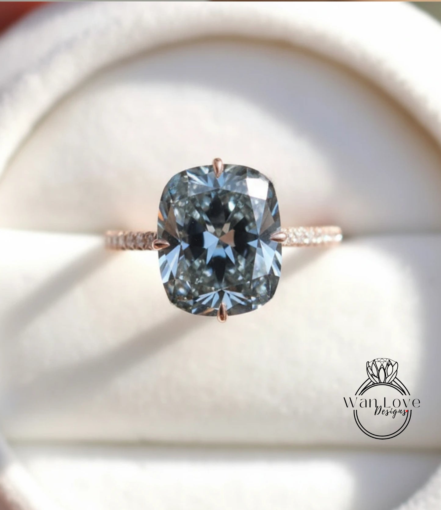 A close-up image of a large, blue diamond ring with a large central stone surrounded by smaller stones.