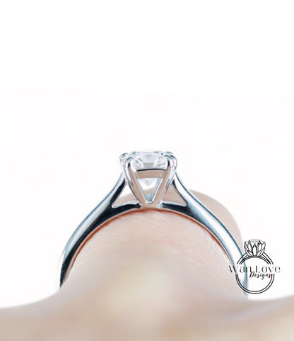 A close-up view of a diamond engagement ring on a person's finger.