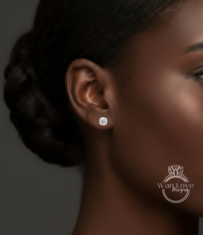 A close-up of a woman's ear with a diamond earring, showcasing the ear and the earring itself.