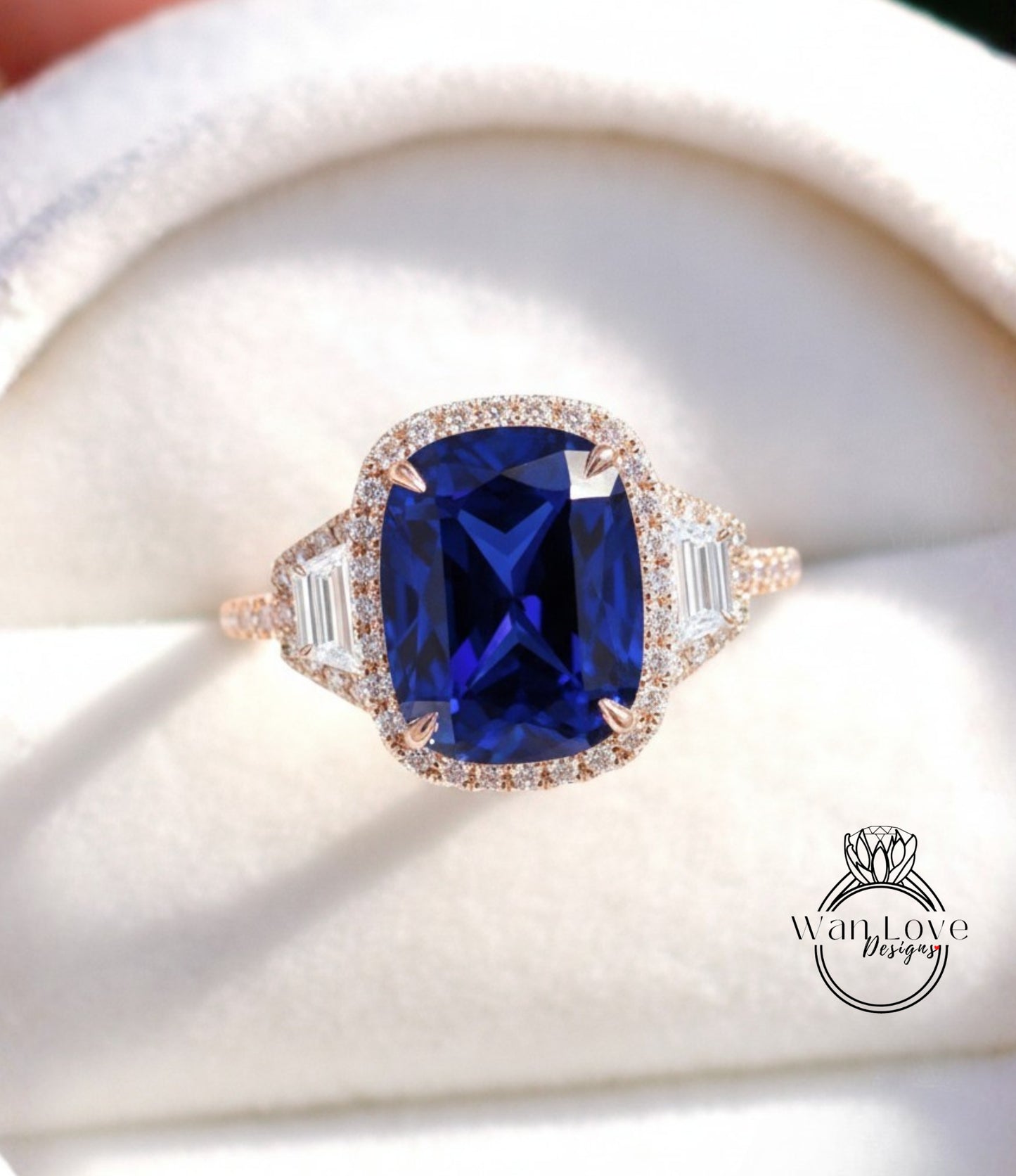 A close-up image of a beautiful blue gemstone ring with a halo of smaller diamonds around the center stone.