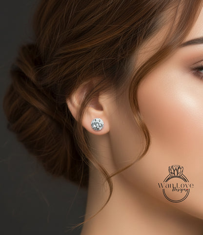 A close-up of a woman's face, focusing on her earrings and hair.