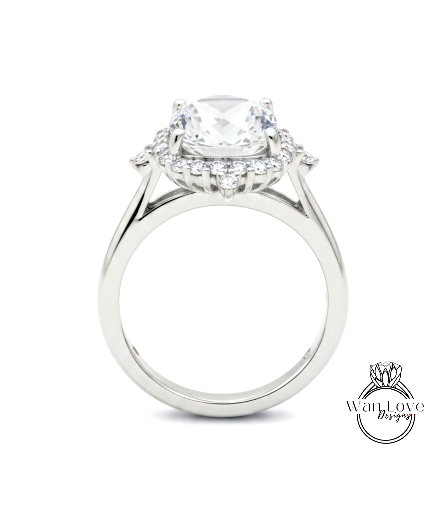 A close-up view of a silver engagement ring with a large central diamond surrounded by smaller diamonds.