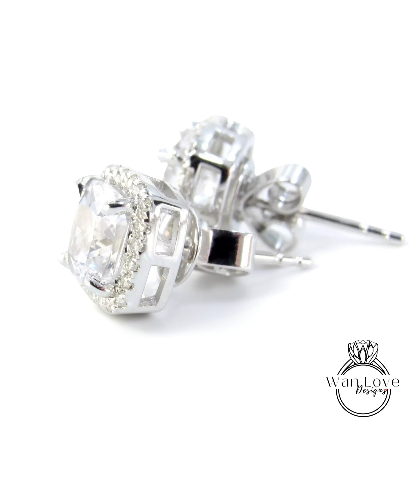 A pair of elegant silver earrings with large, clear gemstones set in a halo-like design.
