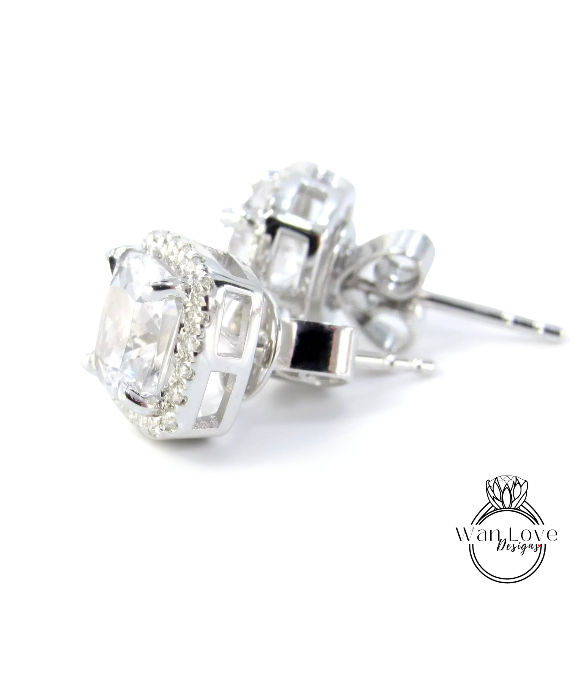 A pair of elegant silver earrings with large, clear gemstones set in a halo-like design.