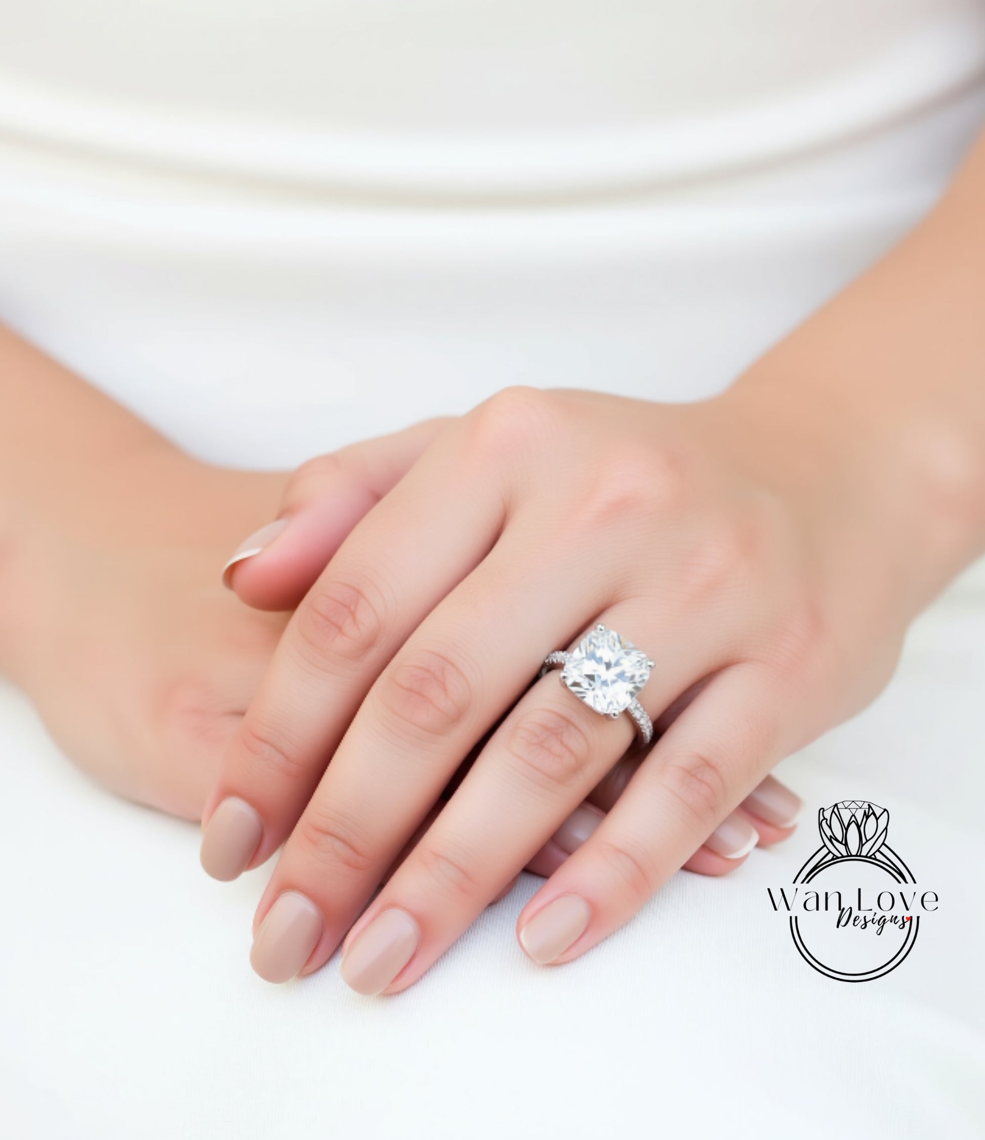 A close-up of a person's hand wearing a large diamond engagement ring.