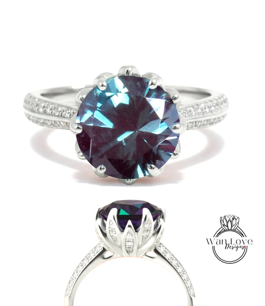 A stunning blue gemstone ring with a large central stone surrounded by smaller stones, set in a silver band with a scalloped edge.