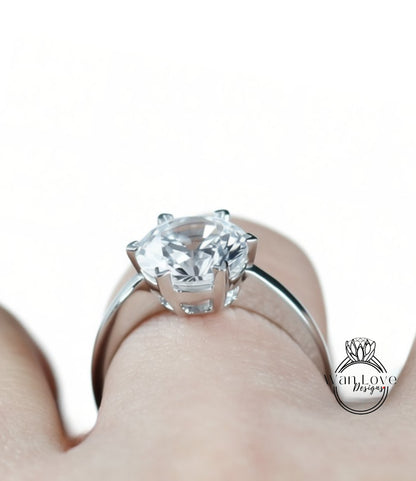 A close-up view of a diamond engagement ring on a person's hand.