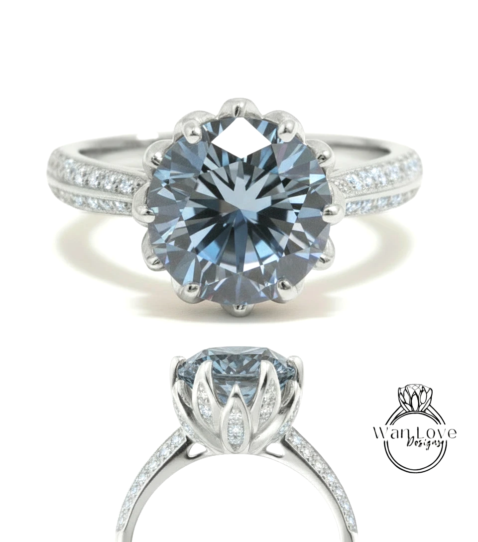 A stunning blue diamond engagement ring with a large central diamond surrounded by smaller diamonds on either side, set in a silver band.