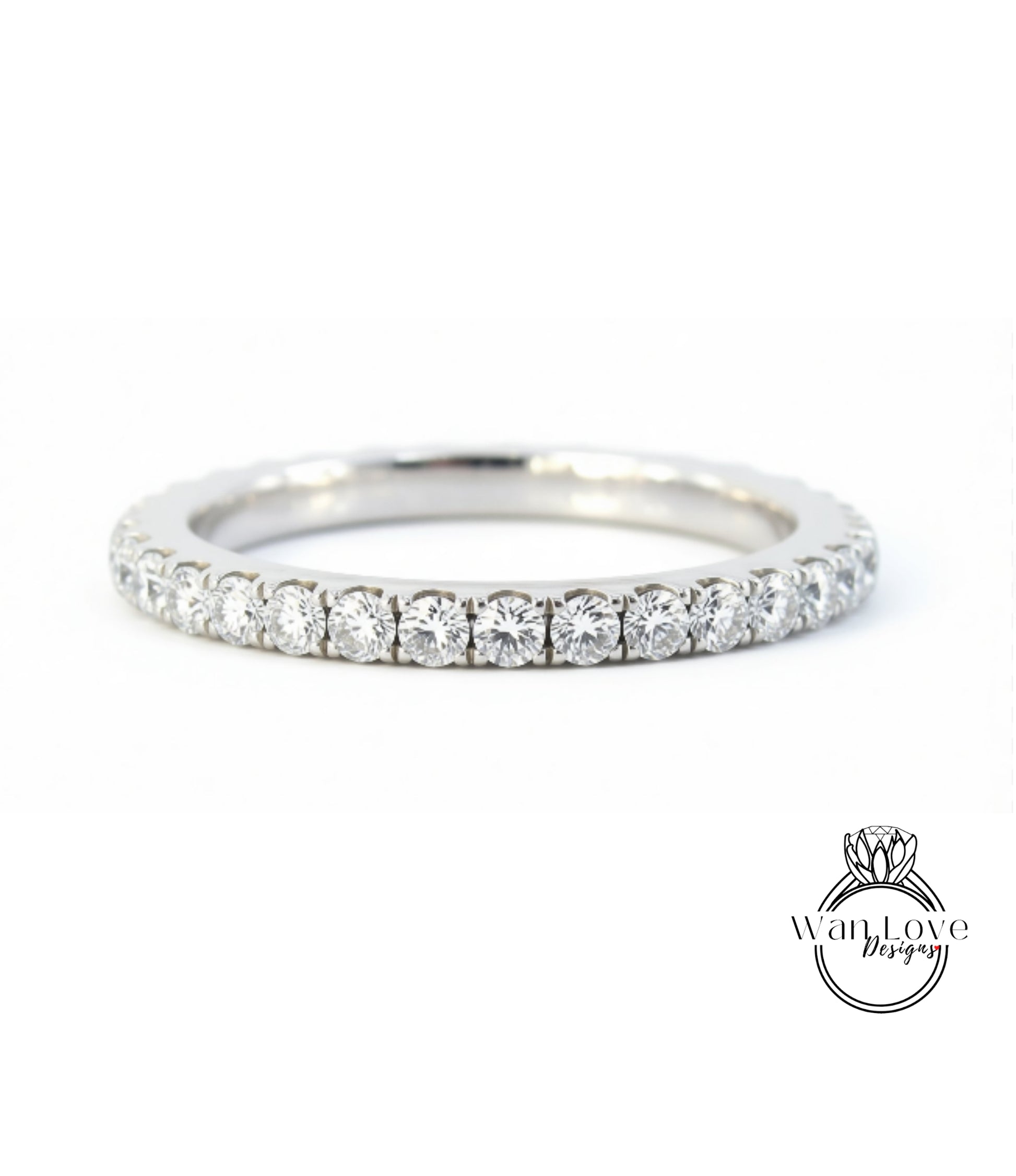 A silver band ring with a row of diamonds set in it.