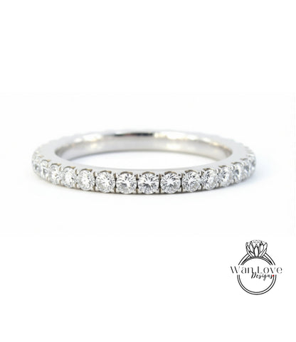 A silver band ring with a row of diamonds set in it.
