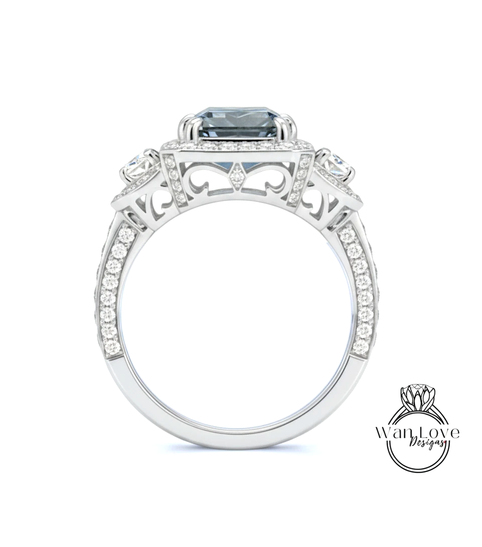 A silver ring with a large blue gemstone, surrounded by smaller diamonds and intricate designs.