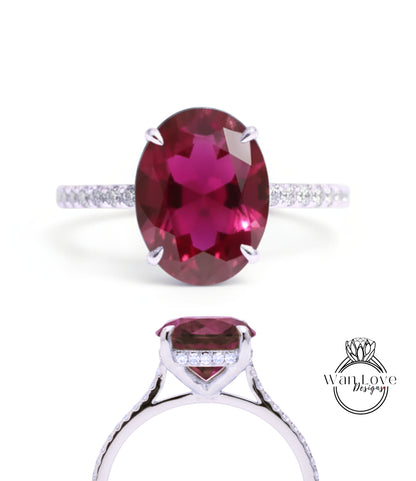 A stunning engagement ring with a large oval-shaped garnet gemstone set in a silver band adorned with small diamonds.