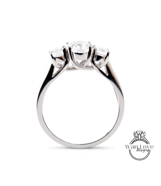 A silver ring with three clear gemstones set in the band.