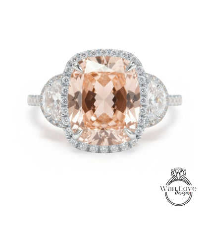 A large, oval-shaped pink gemstone set in a halo of smaller diamonds, surrounded by a halo of smaller diamonds, creating a stunning engagement ring.