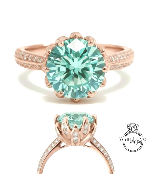 A rose gold ring with a large, round, turquoise-colored gemstone set in the center, surrounded by smaller diamonds.