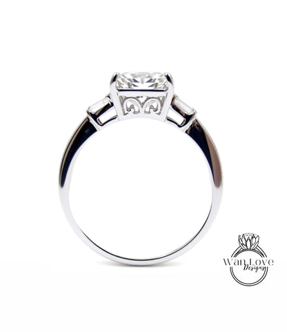 A silver engagement ring with a large central diamond and three smaller diamonds on either side.