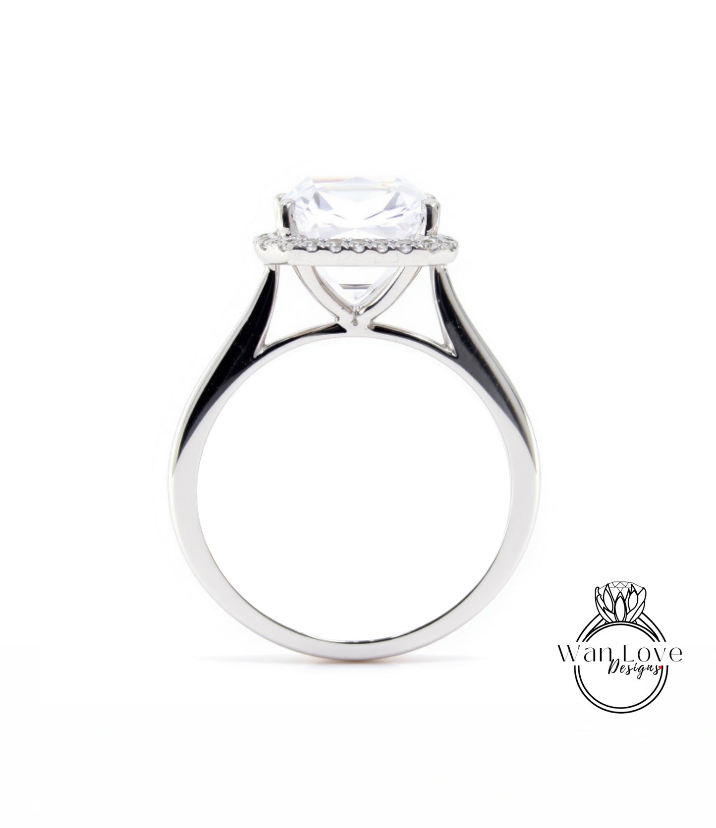 A silver engagement ring with a large, clear gemstone set in the center, surrounded by a halo of smaller diamonds.