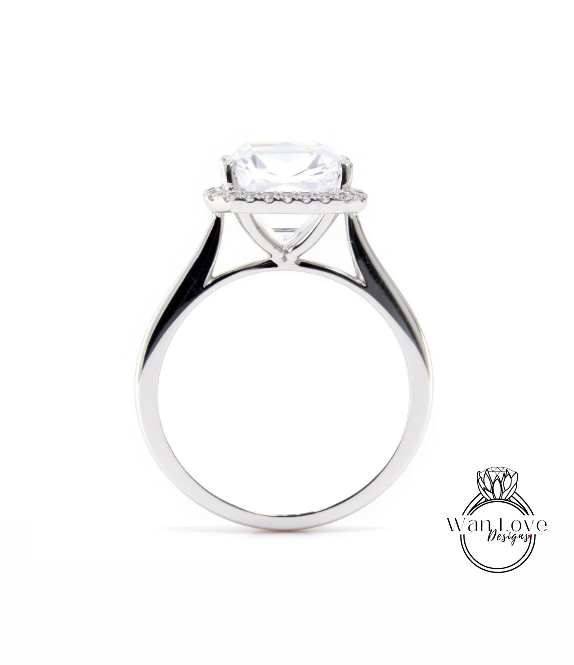A silver engagement ring with a large, clear gemstone set in the center, surrounded by a halo of smaller diamonds.