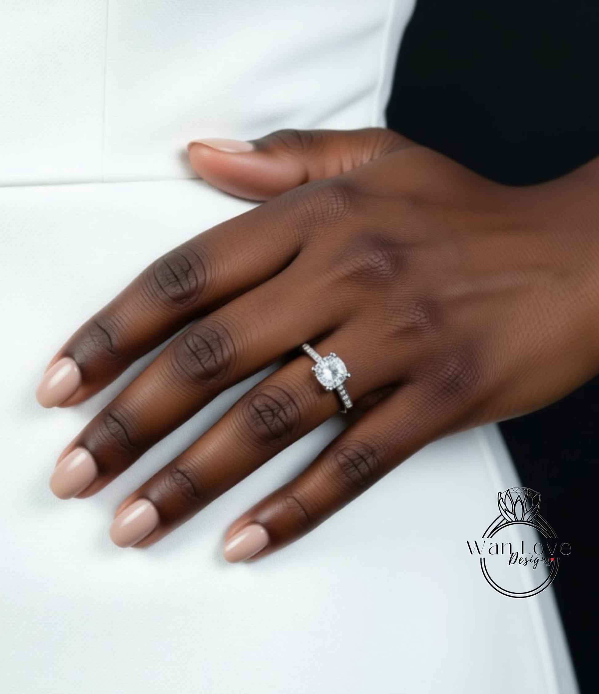 A close-up of a hand wearing a diamond engagement ring.