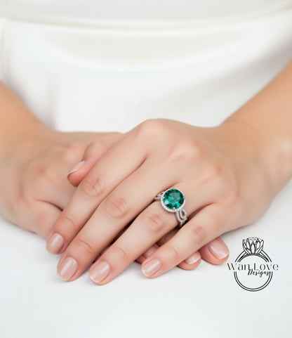 A close-up of a person's hands wearing a ring with a large green gemstone.